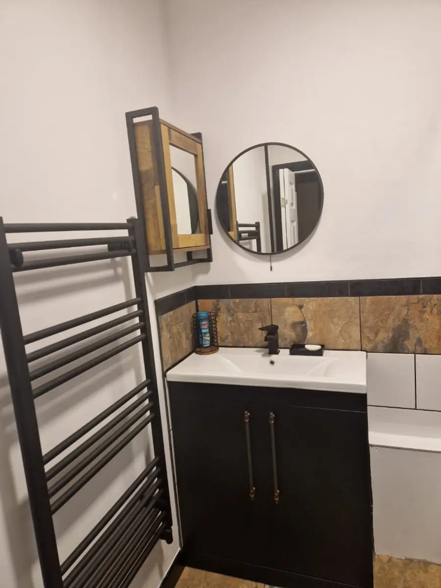Bathroom vanity with heated towel rail and mixer tap